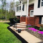 Second photo of recent Manchester NH landscaping job. This photo is taken from the right side, including freshly laid mulch around walkway and flower bed.