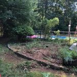 This image shows what the garden looked like during the lawn care services project in Manchester NH. The garden bed is taken apart and many of the plants have been removed.